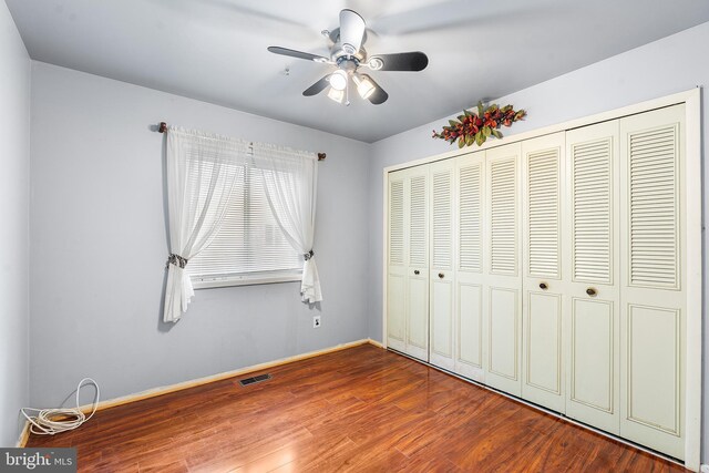 145 Arbor Meadow Dr, Sicklerville, NJ 08081 - unfurnished bedroom with wood finished floors, a closet, baseboards, and a ceiling fan