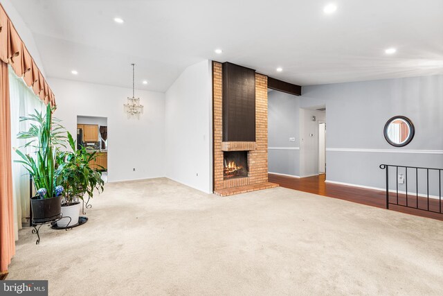 145 Arbor Meadow Dr, Sicklerville, NJ 08081 - unfurnished living room featuring carpet flooring, recessed lighting, a fireplace, lofted ceiling, and a chandelier