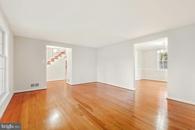 10620 Seneca Ridge Dr, Gaithersburg, MD 20886 - spare room with a chandelier, light wood-style flooring, stairway, and baseboards