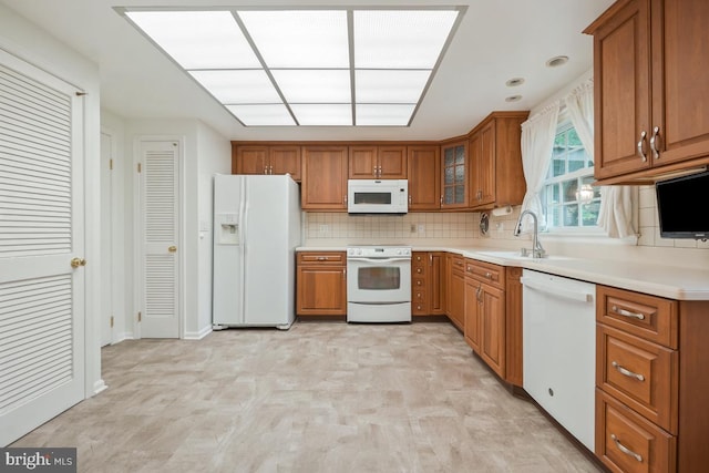 10620 Seneca Ridge Dr, Gaithersburg, MD 20886 - kitchen featuring white appliances, brown cabinetry, a sink, and recessed lighting