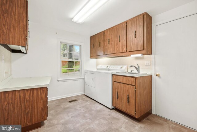10620 Seneca Ridge Dr, Gaithersburg, MD 20886 - clothes washing area with washing machine and dryer, cabinet space, light flooring, and baseboards