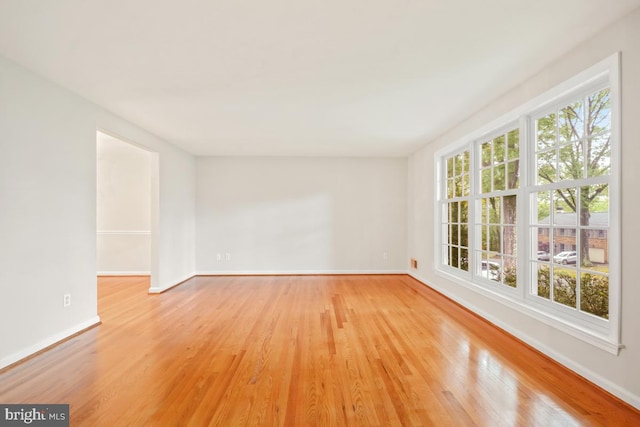 10620 Seneca Ridge Dr, Gaithersburg, MD 20886 - empty room with healthy amount of natural light, light wood-type flooring, and baseboards