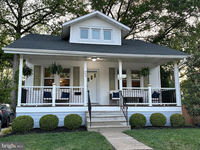 bungalow featuring a porch and a shingled roof