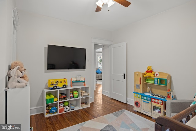 playroom featuring wood finished floors, ceiling fan, and baseboards