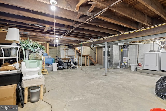 unfinished basement with gas water heater, washer and clothes dryer, heating unit, and stairs