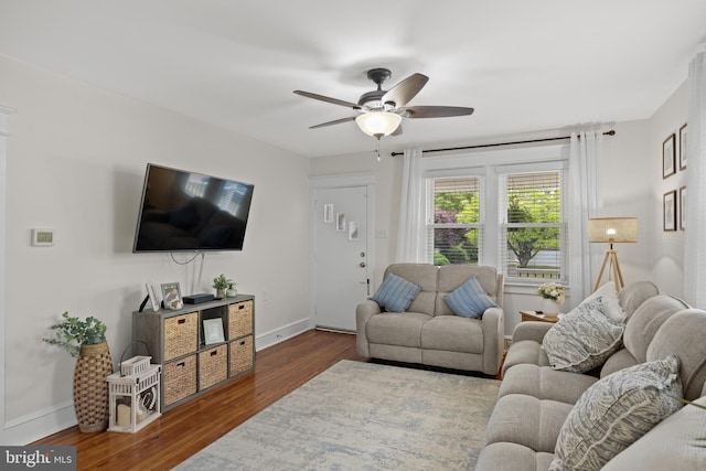 living area with ceiling fan, wood finished floors, and baseboards