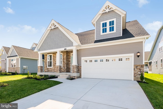 craftsman-style home with stone siding, a front yard, driveway, and roof with shingles