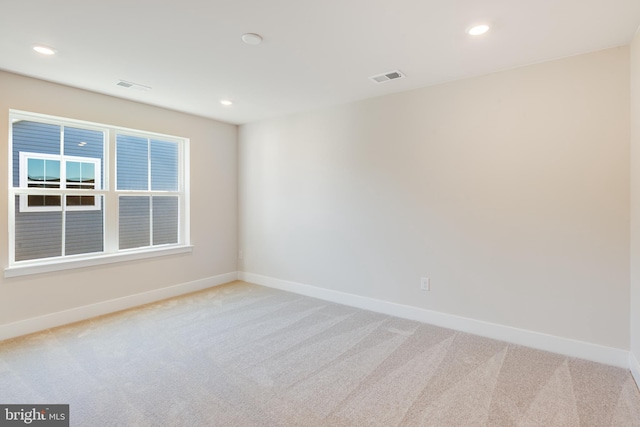 unfurnished room with light carpet, baseboards, and recessed lighting