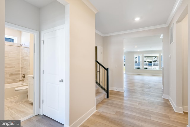 hall featuring ornamental molding, stairs, light wood-style flooring, baseboards, and recessed lighting