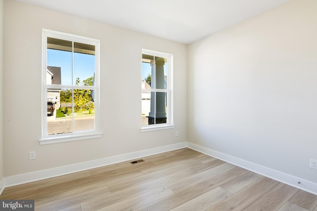 unfurnished room featuring wood finished floors and baseboards