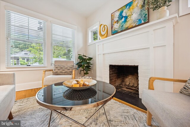 203 Spring Ave, Takoma Park, MD 20912 - living room with wood finished floors, a brick fireplace, and baseboards