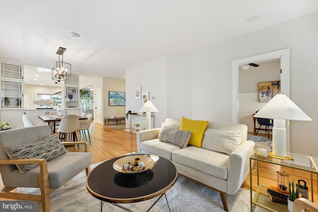 203 Spring Ave, Takoma Park, MD 20912 - living room with light wood-style floors and a chandelier