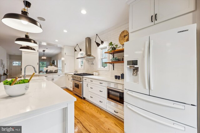 203 Spring Ave, Takoma Park, MD 20912 - kitchen featuring appliances with stainless steel finishes, island exhaust hood, backsplash, white cabinets, and recessed lighting