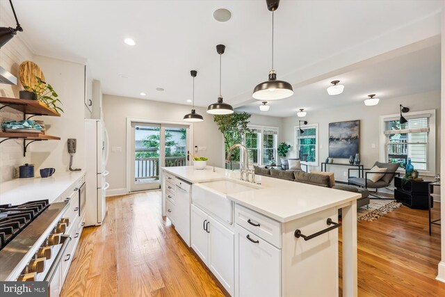 203 Spring Ave, Takoma Park, MD 20912 - kitchen with a sink, open shelves, white appliances, light wood-style flooring, and white cabinets