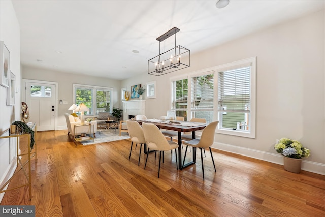 203 Spring Ave, Takoma Park, MD 20912 - dining area with light wood-style flooring, baseboards, and a chandelier