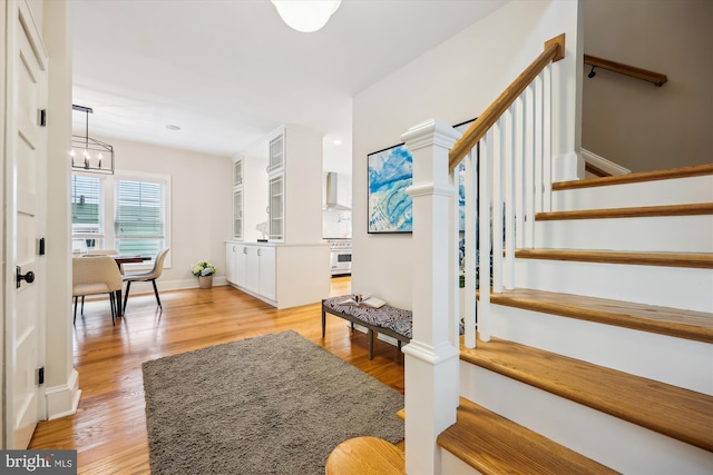 203 Spring Ave, Takoma Park, MD 20912 - foyer featuring stairway, light wood-style floors, a chandelier, and baseboards
