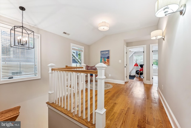 203 Spring Ave, Takoma Park, MD 20912 - corridor featuring an upstairs landing, light wood finished floors, a chandelier, vaulted ceiling, and baseboards