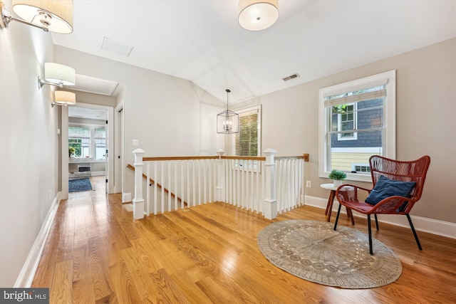 203 Spring Ave, Takoma Park, MD 20912 - corridor with an upstairs landing, wood finished floors, lofted ceiling, baseboards, and a chandelier