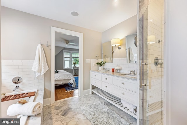 203 Spring Ave, Takoma Park, MD 20912 - ensuite bathroom featuring double vanity, a ceiling fan, a shower stall, marble look tiles, and a bath