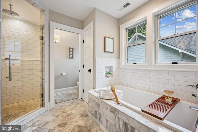 203 Spring Ave, Takoma Park, MD 20912 - full bathroom with a shower stall, a bath, toilet, and baseboards