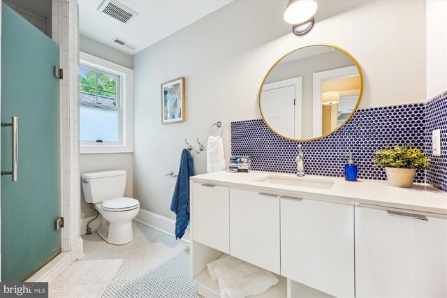 203 Spring Ave, Takoma Park, MD 20912 - bathroom featuring vanity, toilet, a shower stall, tasteful backsplash, and baseboards