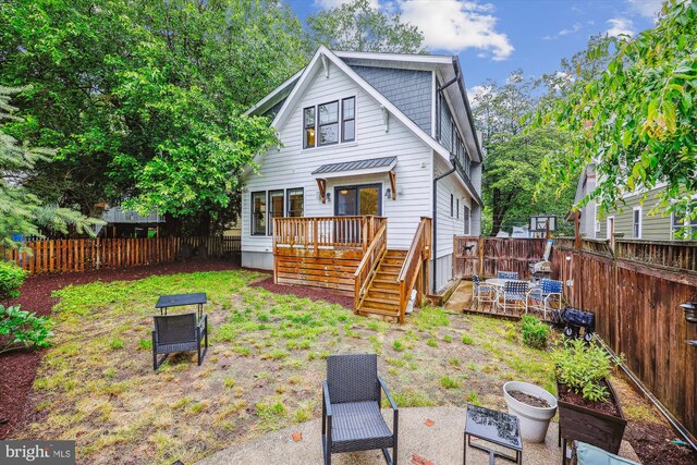 203 Spring Ave, Takoma Park, MD 20912 - back of property featuring a fenced backyard, a deck, and stairway