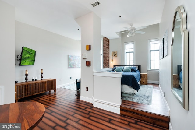 bedroom with baseboards and wood finished floors