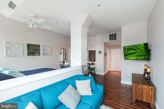 living area featuring wood finished floors, ceiling fan, and baseboards