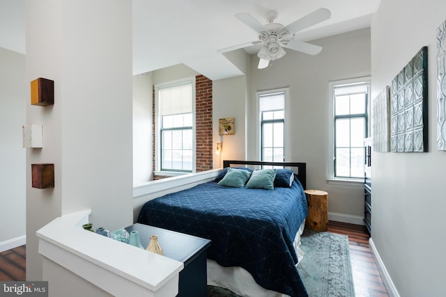 bedroom featuring dark wood-style floors, baseboards, and a ceiling fan
