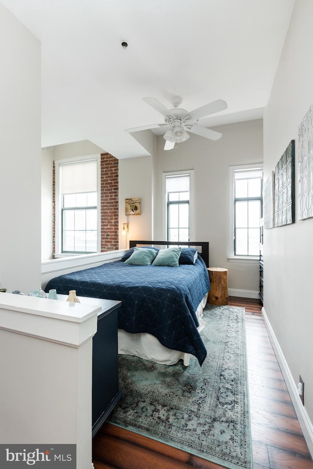 bedroom featuring wood finished floors and baseboards