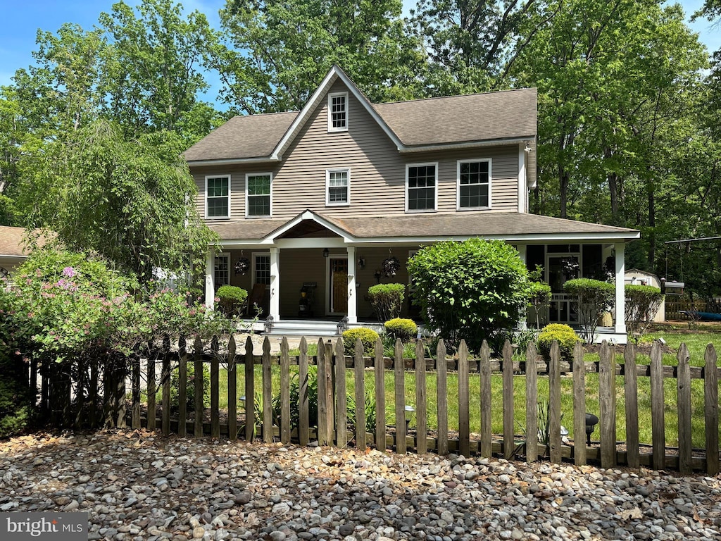 1220 Woolman Ln, Hainesport, NJ 08036 - view of front of property featuring a porch, roof with shingles, and a fenced front yard