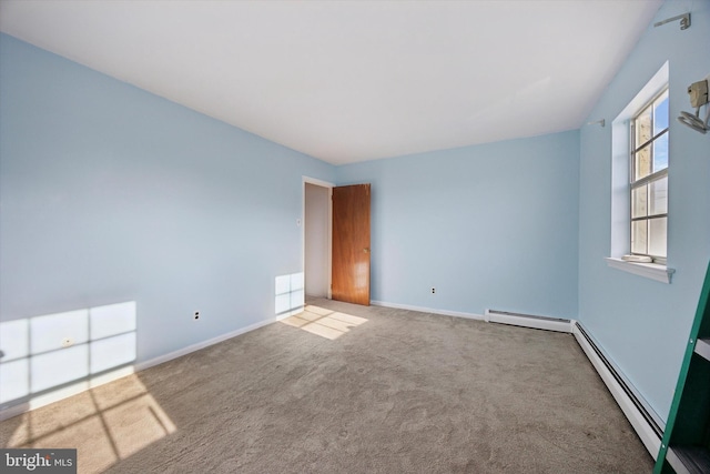 unfurnished room with a baseboard heating unit, carpet, and baseboards
