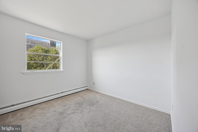 carpeted empty room featuring a baseboard radiator and baseboards