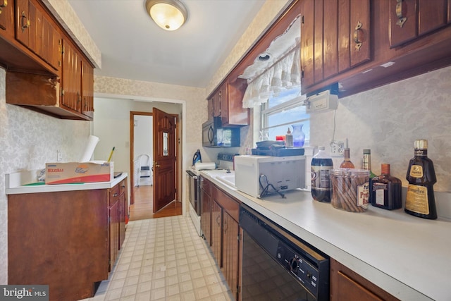 kitchen with black appliances, light countertops, and light flooring