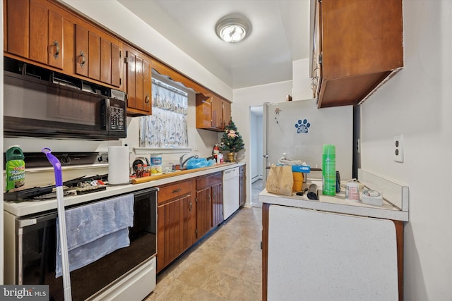 kitchen with white appliances, brown cabinets, light countertops, and a sink
