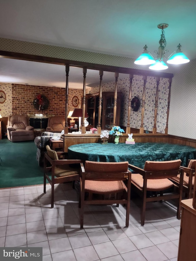dining area with wallpapered walls, wainscoting, and light tile patterned floors