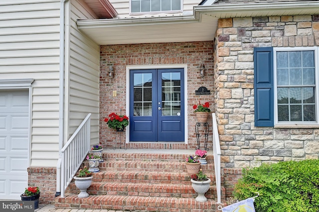 doorway to property featuring stone siding and french doors