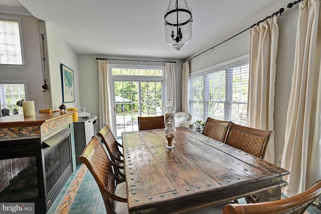 tiled dining area with a fireplace