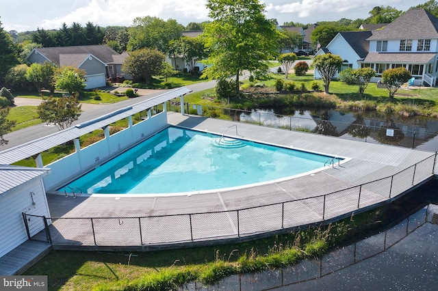 view of pool with fence and a residential view