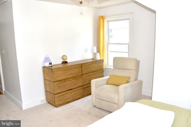 living area with light colored carpet and baseboards