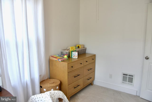 bedroom with light carpet and baseboards
