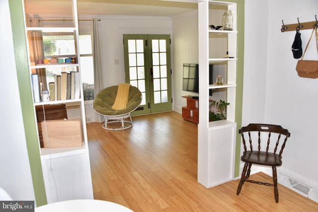 living area with french doors and wood finished floors