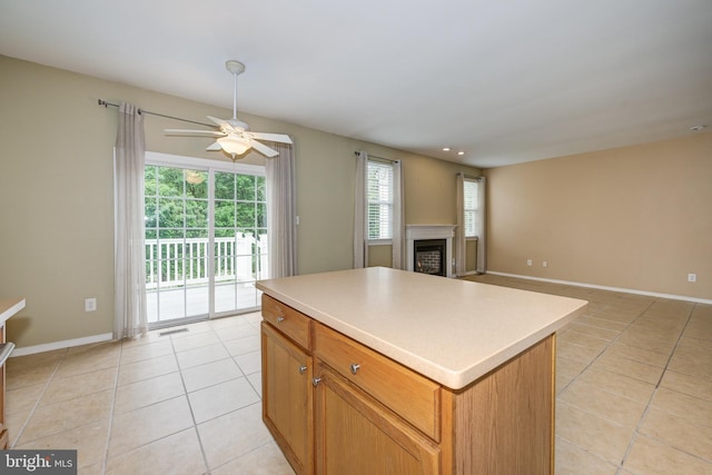 221 Heritage Way, Deptford, NJ 08096 - kitchen with light tile patterned flooring, a ceiling fan, a center island, and a fireplace