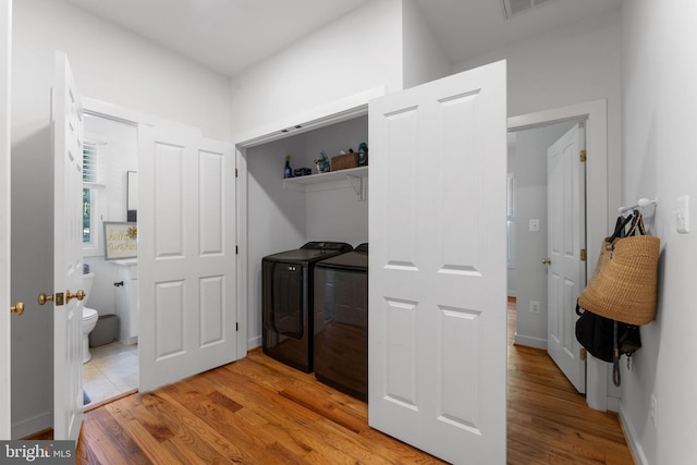 5194 Chase Ln, Midland, VA 22728 - laundry room with washing machine and dryer and light wood finished floors