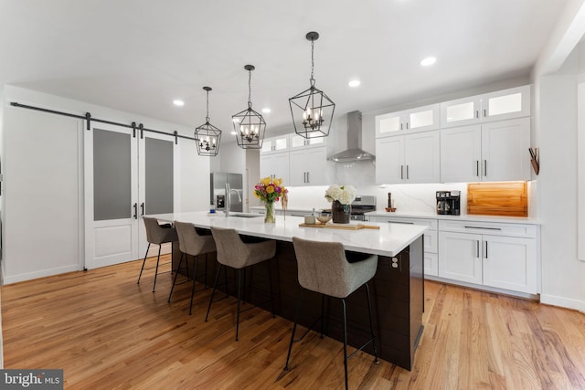 5194 Chase Ln, Midland, VA 22728 - kitchen featuring wall chimney exhaust hood, stainless steel appliances, light countertops, white cabinetry, and a large island
