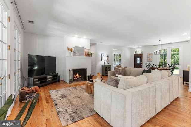 5194 Chase Ln, Midland, VA 22728 - living area with light wood-type flooring, a fireplace with flush hearth, french doors, and recessed lighting