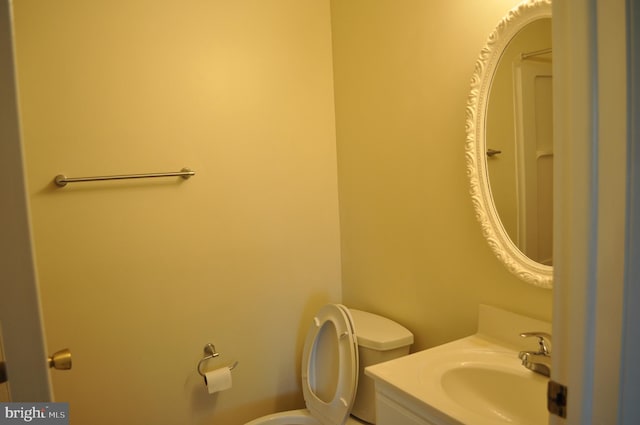 half bathroom with toilet and vanity