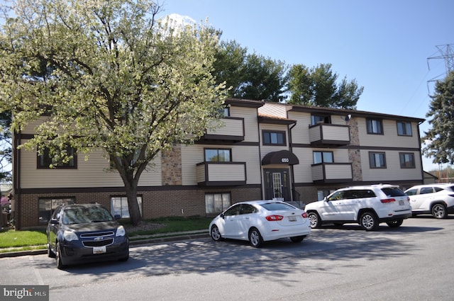 view of building exterior featuring uncovered parking