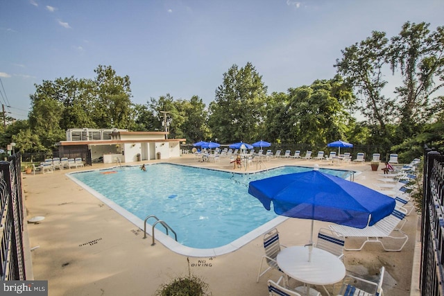 4600 Duke St Unit 512, Alexandria, VA 22304 - community pool featuring a patio and view of wooded area