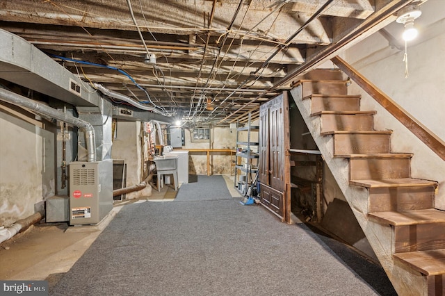 unfinished basement with heating unit and stairway